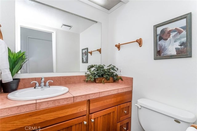 bathroom featuring vanity and toilet