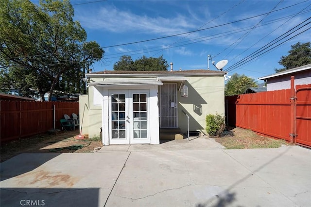 back of property featuring a patio area and french doors