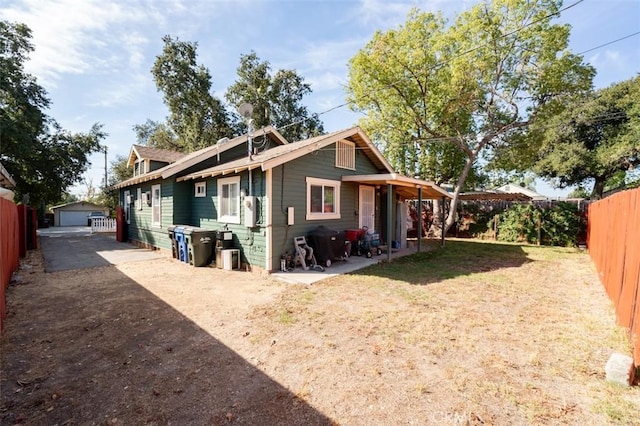 exterior space with an outbuilding, a front lawn, and a garage