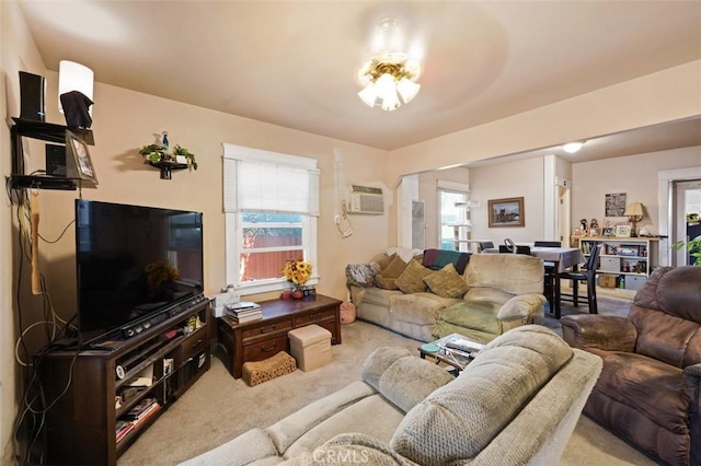 living room featuring carpet, a wall mounted air conditioner, and a wealth of natural light