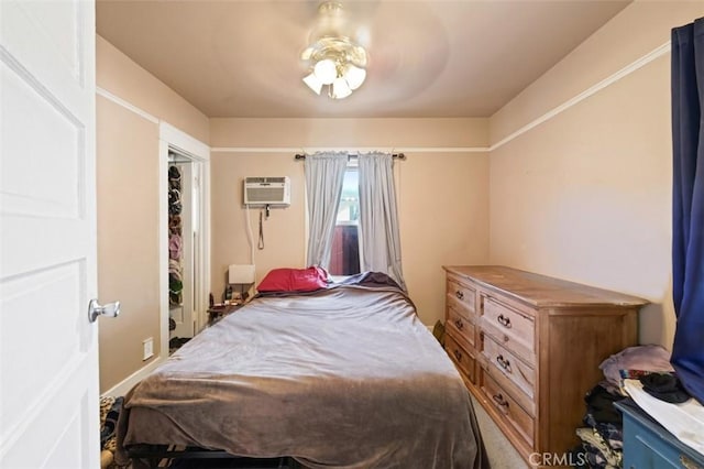 bedroom featuring an AC wall unit and a closet