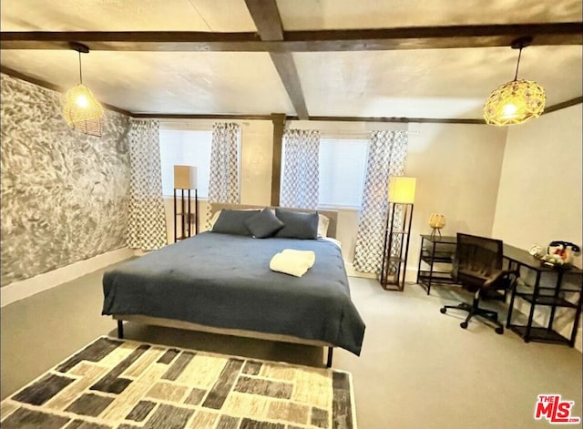 bedroom featuring multiple windows, beamed ceiling, and carpet