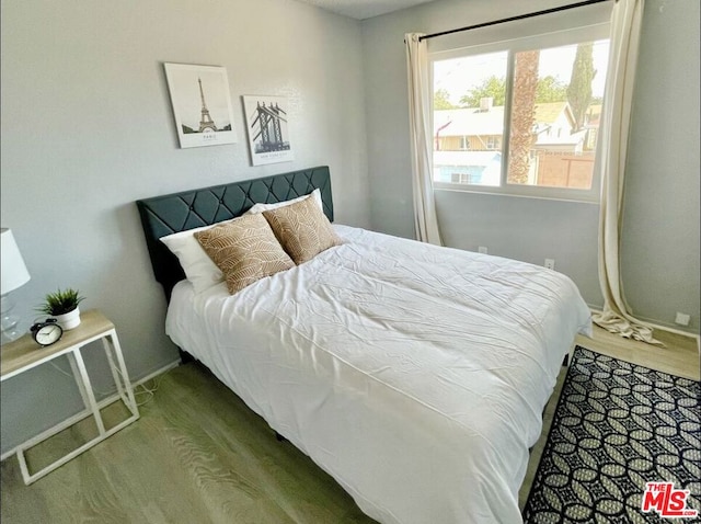 bedroom with hardwood / wood-style floors