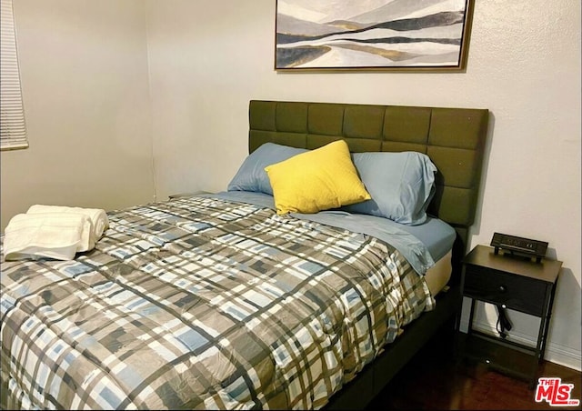 bedroom featuring dark wood-type flooring