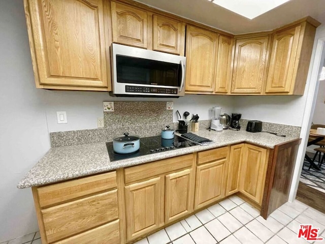 kitchen featuring black electric cooktop and light tile patterned floors