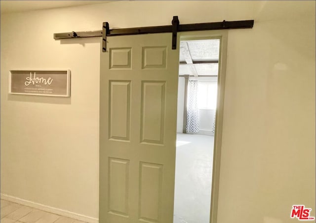 hall featuring a barn door