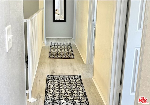 corridor with light hardwood / wood-style floors