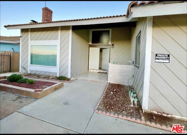 property entrance featuring a patio area