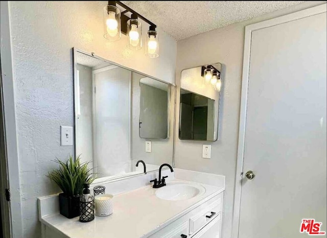 bathroom featuring vanity and a textured ceiling