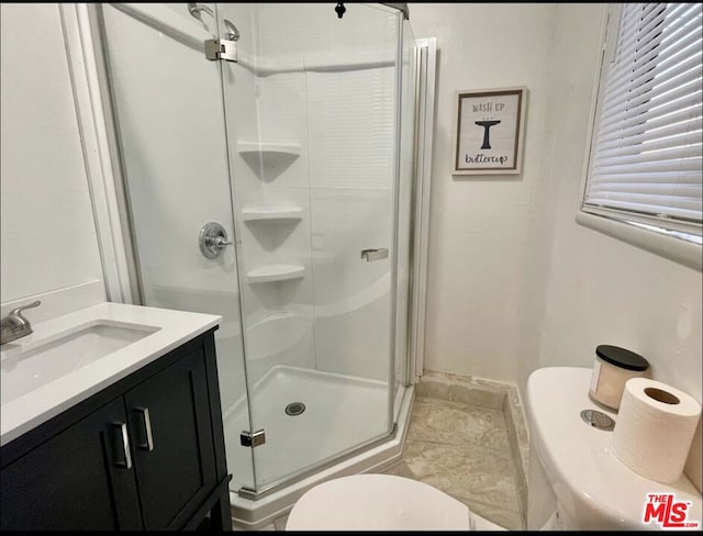 bathroom with vanity, toilet, and an enclosed shower