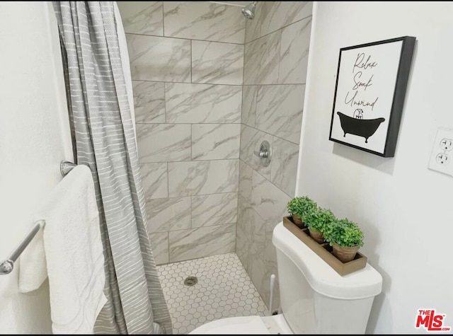 bathroom featuring toilet and walk in shower