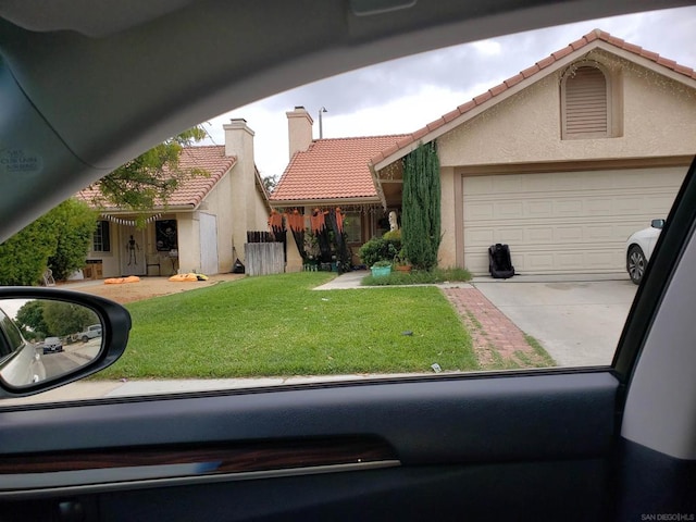 view of front of home with a garage and a front lawn