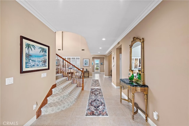 foyer featuring ornamental molding and light tile patterned floors