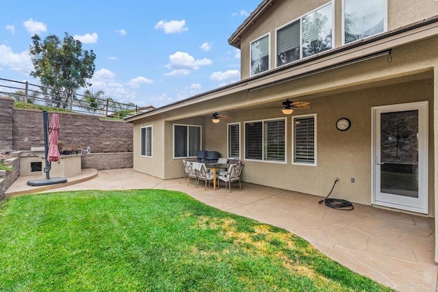 back of house with a yard, ceiling fan, and a patio