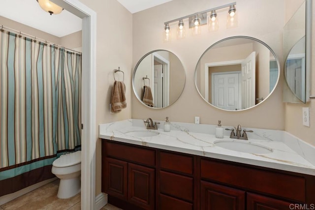 bathroom featuring toilet, vanity, a shower with shower curtain, and tile patterned flooring