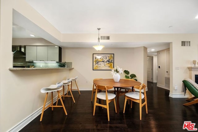 dining space featuring dark wood-type flooring