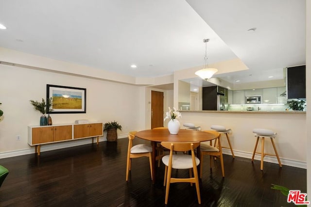 dining room with dark hardwood / wood-style floors