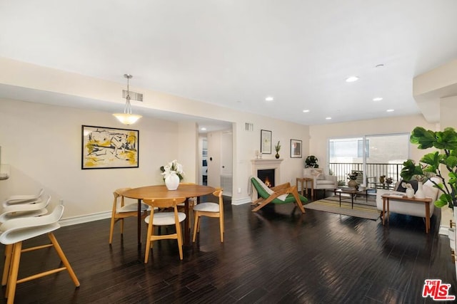 dining area with dark wood-type flooring