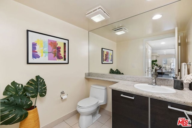 bathroom with toilet, tile patterned flooring, and vanity