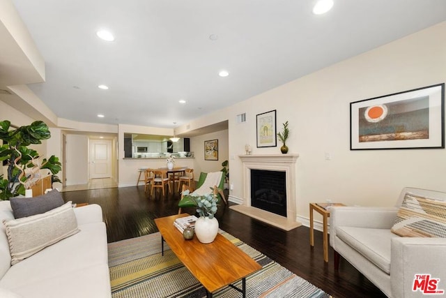 living room with dark hardwood / wood-style flooring