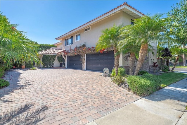 mediterranean / spanish house featuring a garage