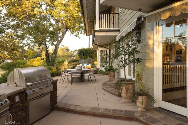 view of patio / terrace featuring a grill, an outdoor kitchen, and a balcony