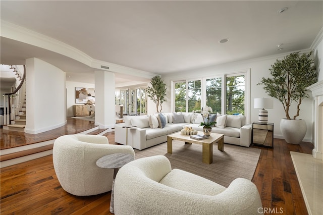 living room with crown molding and hardwood / wood-style floors