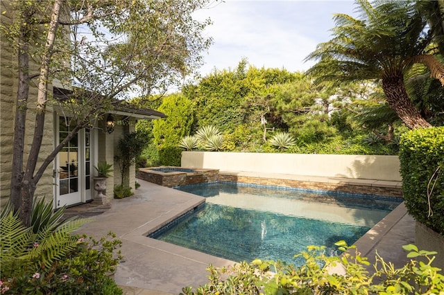 view of swimming pool with a patio area and an in ground hot tub