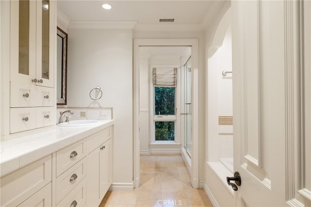 bathroom featuring vanity, ornamental molding, and shower with separate bathtub