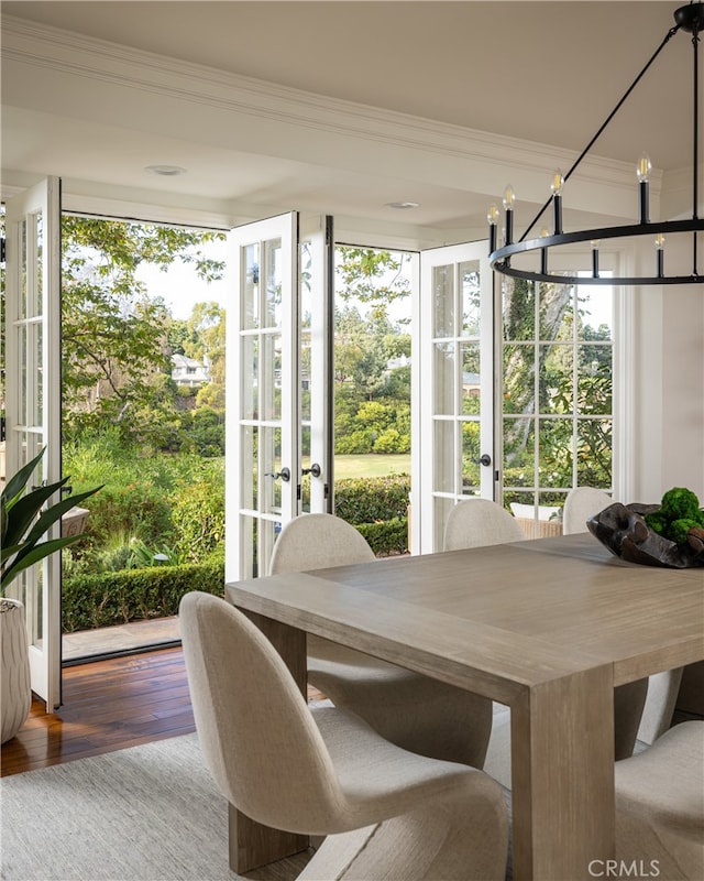 sunroom / solarium with french doors and a chandelier