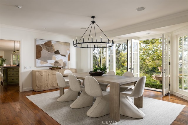 dining area with crown molding, a healthy amount of sunlight, and dark hardwood / wood-style flooring