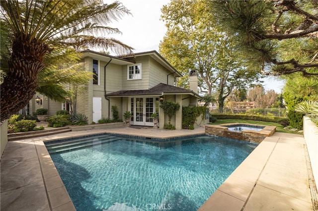 view of pool featuring a patio area, french doors, and an in ground hot tub