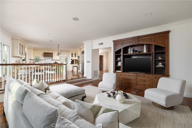 living room with crown molding and dark hardwood / wood-style flooring