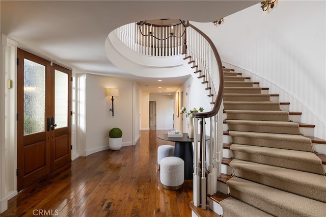 foyer entrance featuring french doors and dark hardwood / wood-style floors