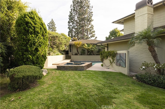 view of yard with an in ground hot tub