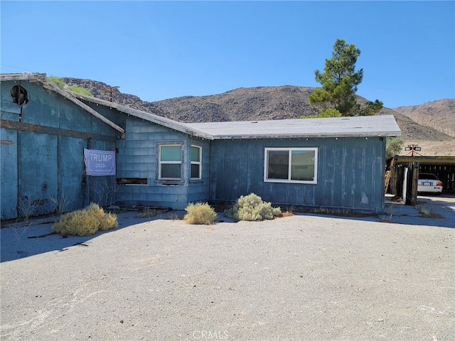 exterior space with a mountain view and a carport