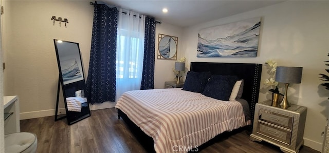 bedroom with dark hardwood / wood-style flooring