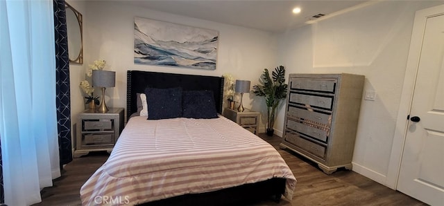 bedroom with dark wood-type flooring