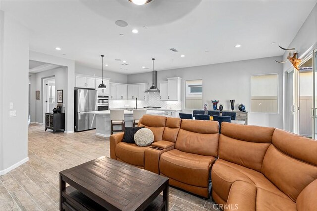 living room featuring light hardwood / wood-style floors and sink