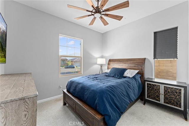 bedroom featuring light colored carpet and ceiling fan