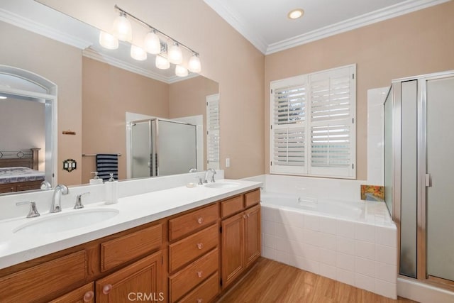 bathroom with wood-type flooring, vanity, shower with separate bathtub, and ornamental molding