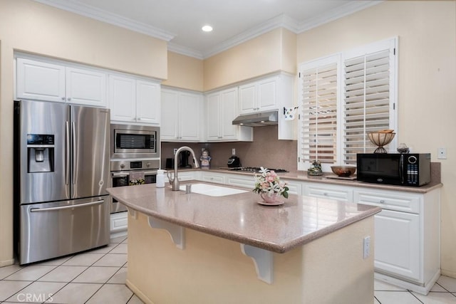 kitchen with appliances with stainless steel finishes, a center island with sink, white cabinetry, and sink