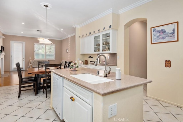 kitchen featuring sink, hanging light fixtures, white dishwasher, a kitchen island with sink, and white cabinets