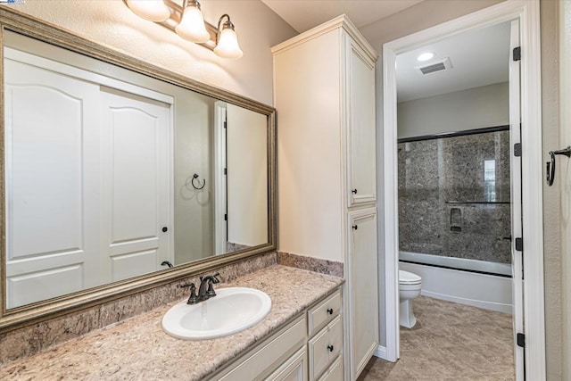 full bathroom featuring tile patterned flooring, vanity, toilet, and enclosed tub / shower combo