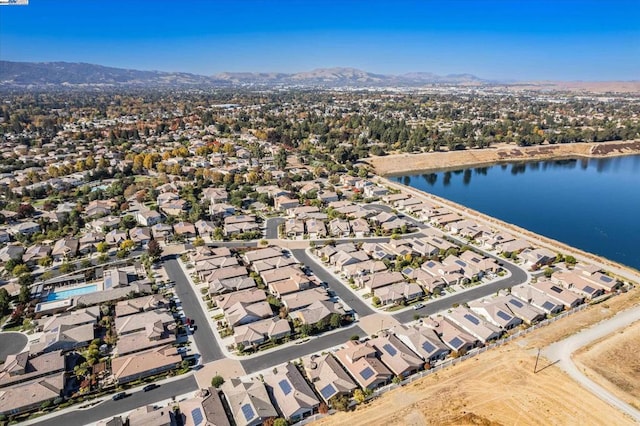 birds eye view of property with a water and mountain view