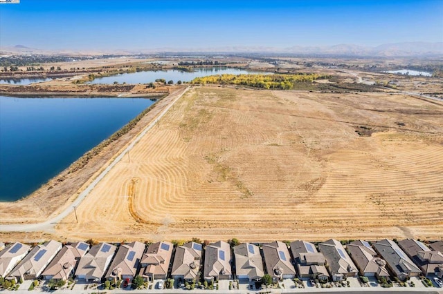 birds eye view of property featuring a water and mountain view