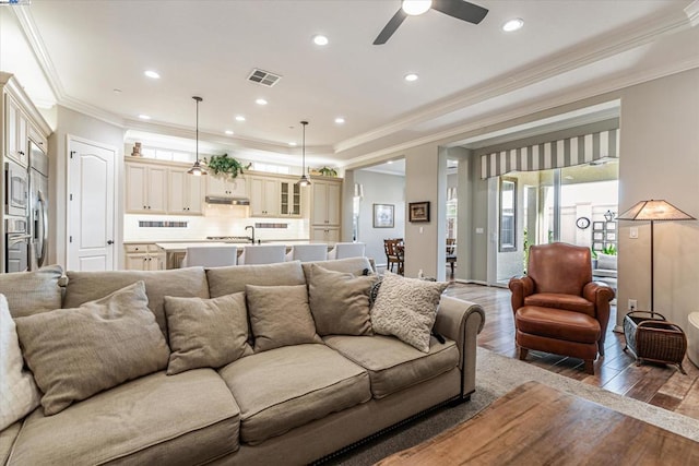 living room featuring ceiling fan, dark hardwood / wood-style flooring, and crown molding