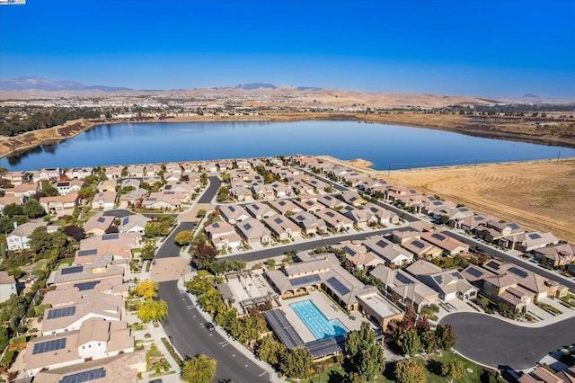 birds eye view of property featuring a water and mountain view