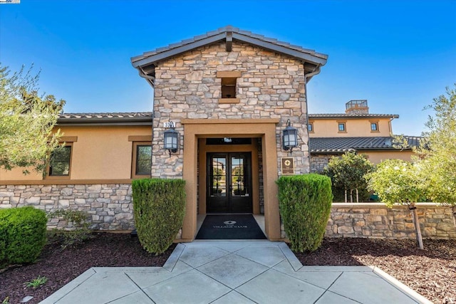 property entrance featuring french doors