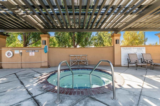 view of swimming pool featuring a community hot tub and a patio area